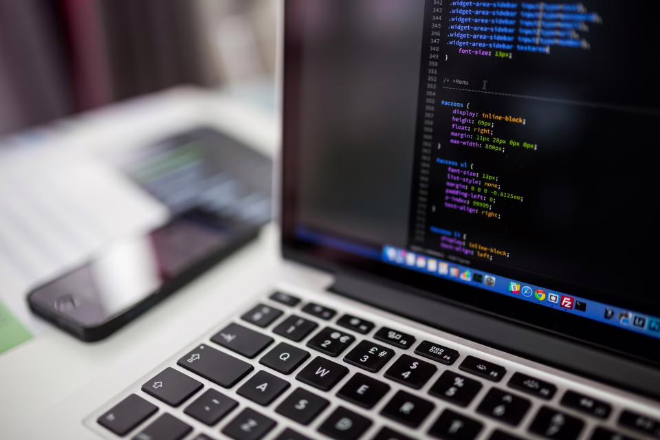 Laptop screen displaying code in a development environment