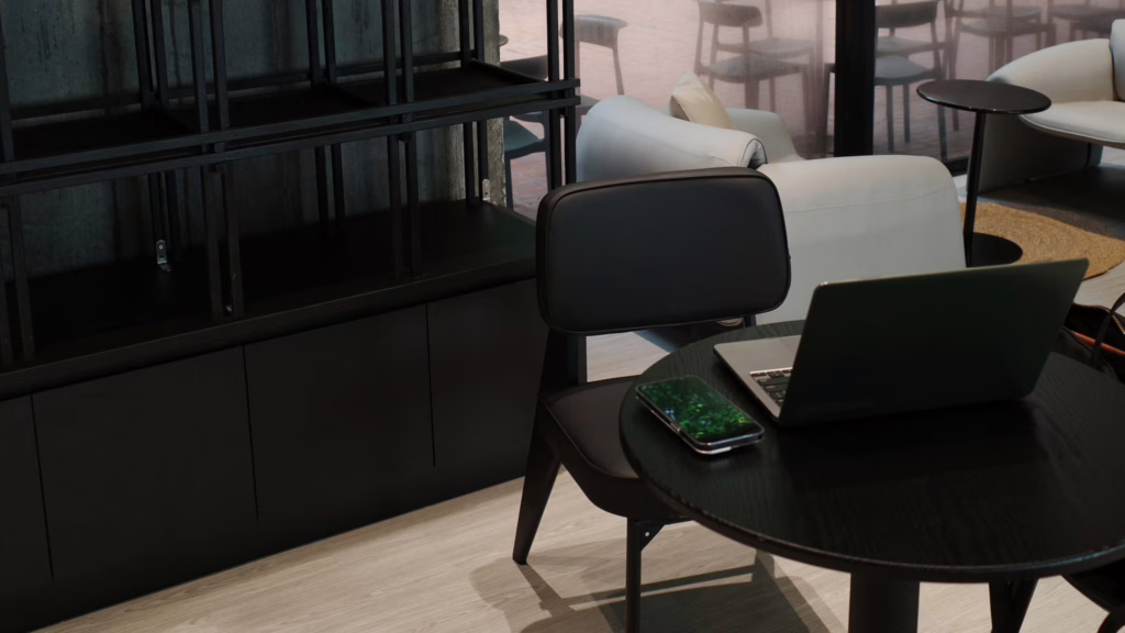 Minimal black-table workspace with a modern laptop
