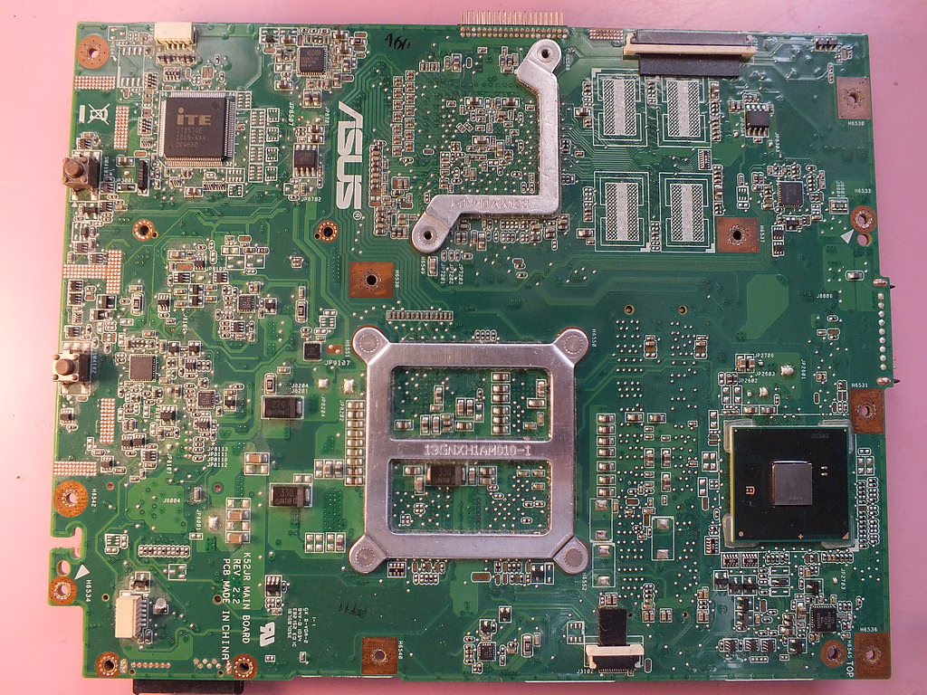 Closeup of a motherboard with slots and components visible